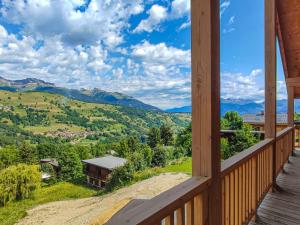 a view from the porch of a cabin with mountains in the background at Chalet Les Avanchers-Valmorel, 4 pièces, 6 personnes - FR-1-356-376 in Les Avanchers