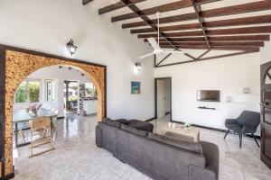 a living room with a couch and a table at Villa Joelena in Lachi