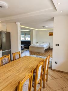 a room with a table and a bed in the background at Villa Sara in Sarajevo