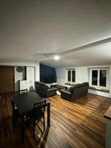 a living room with two couches and a table at F3 cosy - coeur nanterre- commerces et transports in Nanterre