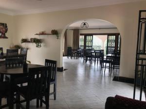 an empty dining room with tables and chairs at The Fortuna Apartment in Kabale