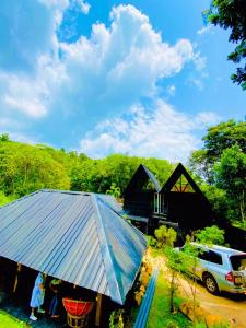 a house with a blue metal roof in front of it at Forestar Villa and Restaurant in Nittambuwa