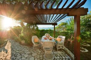 a table and chairs under a wooden pergola at Sun Spalato Hills 8 in Split