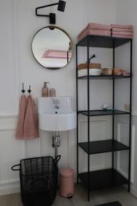 a bathroom with a sink and a mirror at B&B nr.15 in Vries