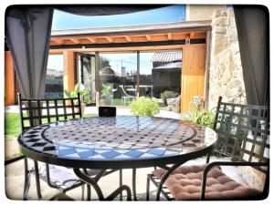 a patio with a table and chairs on a patio at La Mirada de Amelia 