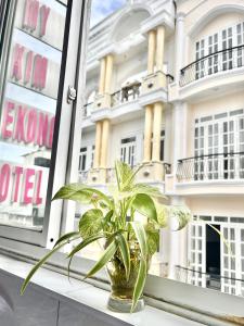 a plant in a vase sitting on a window sill at My Kim Hotel - Ngay Bến Ninh Kiều in Can Tho +24 photos