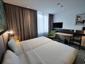 Posteľ alebo postele v izbe v ubytovaní Mercure Warszawa Grand