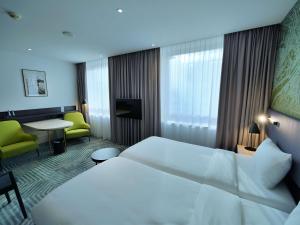 Posteľ alebo postele v izbe v ubytovaní Mercure Warszawa Grand