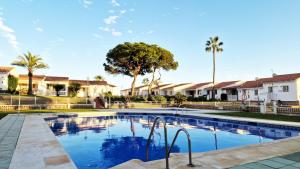 a swimming pool with palm trees and houses at AA Guest - Mi Casa Eco Front Sea Views in Mijas Costa