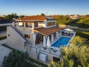 an aerial view of a house with a swimming pool at CASA MARE ISTRIA, villa with private pool, near the beach, with the sea view! in Peroj