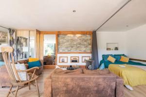 a bedroom with a bed and a couch at Le Bonheur En Beaujolais - pour 26 Personnes in Saint-Didier-sur-Beaujeu +39 photos