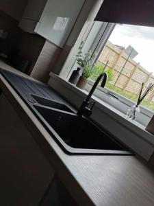 a black umbrella sitting on a counter next to a window at Limekilns House in Clydebank