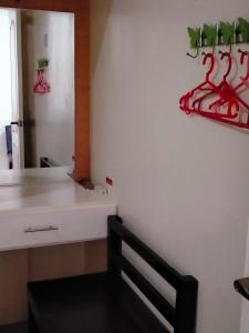 a room with a white wall with red hangers at V.F. Riton Apartelle in Laoag +55 photos