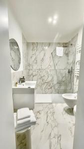 a white bathroom with a sink and a toilet at Locanda Cà Del Console in Venice