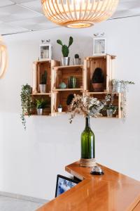 a vase with flowers on a table in a room at Hotel Isla Menor in Dos Hermanas