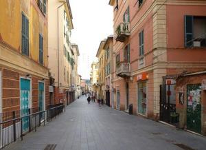 an empty street in a city with buildings at M Home Genova Sestri Ponente 010025-LT-1596 in Genoa