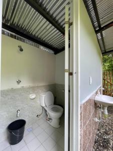 a bathroom with a toilet and a sink at Hillcreek's Riverside Hideaway in Murcia