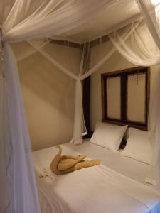 a towel on a bed in a bedroom at BaliFarmhouse in Banjarangkan