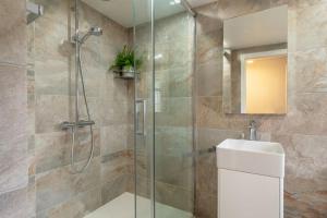 a bathroom with a glass shower and a sink at Crown Street 4 in Bury Saint Edmunds