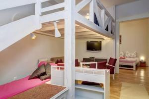 a bedroom with a bunk bed and a living room at City and Calmness in Budapest
