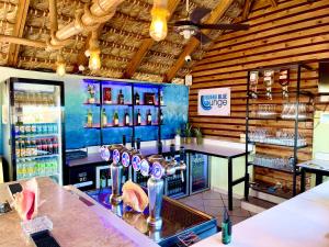a bar with a counter with a lot of drinks at Villa Iguana in Bayahibe