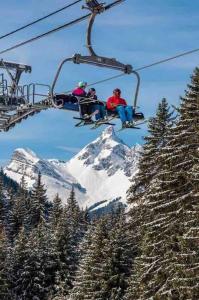 a group of people riding a ski lift at Studio très lumineux 4 pers in Les Carroz d'Araches