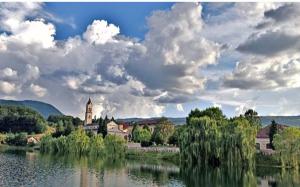 a large body of water with a building and a church at Kuća za odmor Jeličić 