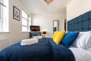 a large blue bed with two pillows on it at Smart Apartments - Atlantic Mansions in Southampton