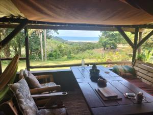 a room with a table and a view of the ocean at Casa Ariel - River Lodge in Port Edward