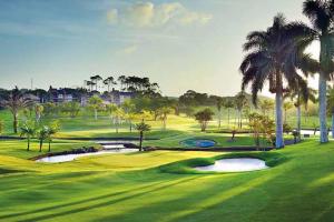 a painting of a golf course with palm trees at Casa Ariel - River Lodge in Port Edward