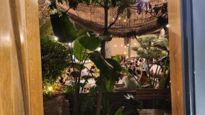 a crowd of people sitting at tables in a restaurant at Barry Hotel in Izmir