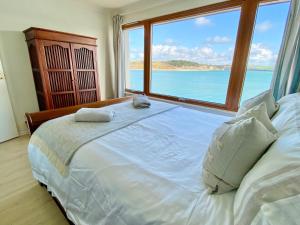 a bedroom with a bed with a view of the ocean at 14 The Old Boatyard in Padstow