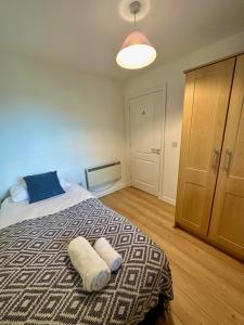 a bedroom with a bed with two towels on it at Overlooking city centre apt in Waterford