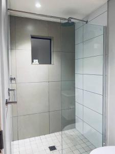 a shower with a glass door in a bathroom at The Heaven on Earth Hosted By Jose & Teresa in Cape Town