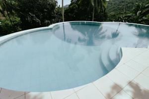 a large swimming pool with blue water at Shepherds Ridge powered by Cocotel in Mabitac