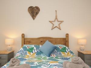 a bedroom with a bed with a star on the wall at Minack in Bude