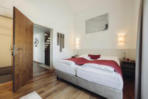 a bedroom with a bed and a wooden floor at Mooser Living in Sankt Anton am Arlberg