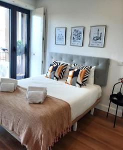 a large bed with pillows on it in a bedroom at Smiling Places - Apartment in Porto in Porto