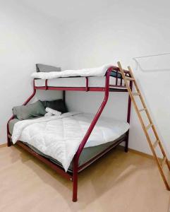 two bunk beds in a room with a ladder at Cheerful 27 Home with BBQ grill in Cheras