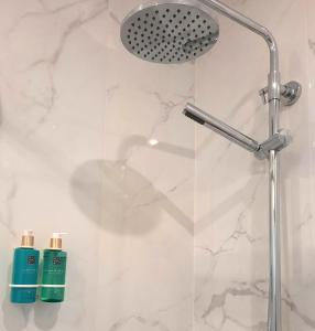 a shower with two bottles of green shampoo at Smiling Places - Apartment in Porto in Porto