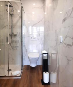 a bathroom with a toilet and a glass shower at Smiling Places - Apartment in Porto in Porto