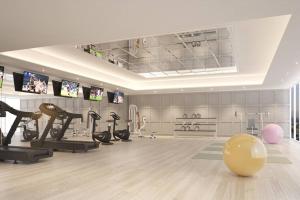 a fitness room with a gym with exercise equipment at chateau in-town ratchayothin BTS in Ban Yang