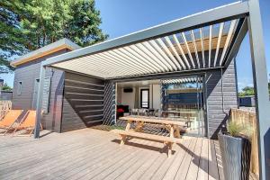 a wooden deck with a picnic table and a building at Le Chalet d'Angel in Jullouville-les-Pins