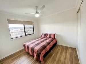 1 dormitorio con 1 cama en una habitación con ventana en Stay at Mandi’s, en Kingston