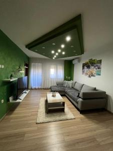 a living room with a couch and a tv at Aby in Slavonski Brod