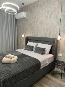 a bedroom with a bed with two towels on it at Vanquish Central Apartment in Varna City