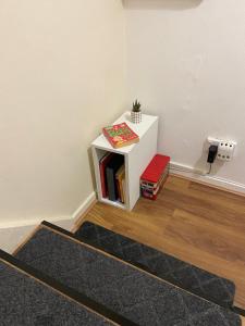 a book shelf in a corner of a room at Single and doubles rooms close to central London in London