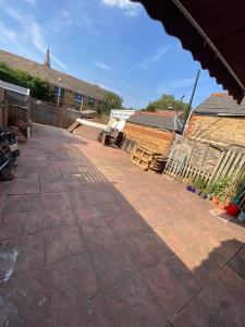 a backyard with a brick patio and a building at Single and doubles rooms close to central London in London