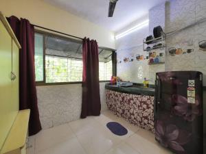 a kitchen with a sink and a window in a room at DawnsMelody in Mumbai
