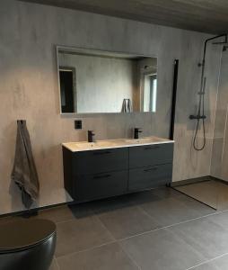 a bathroom with a sink and a mirror at Stylish cabin at Lifjell with jacuzzi and sauna in Bø